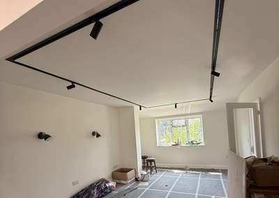 Ceiling track lighting and wall spots installed during a refurbishment