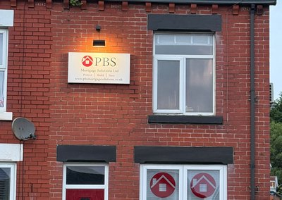 Illuminated sign light fitted above a business sign