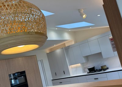 Kitchen lighting with a woven pendant, spotlights and downlights